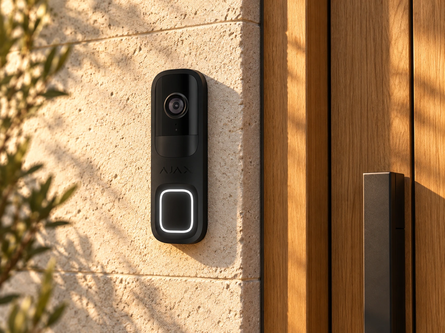 Illustrative Ajax DoorBell installation on a limestone wall beside an oak entrance door.
